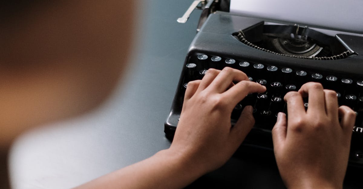 Man Writing on an Old Type Machine · Free Stock Photo