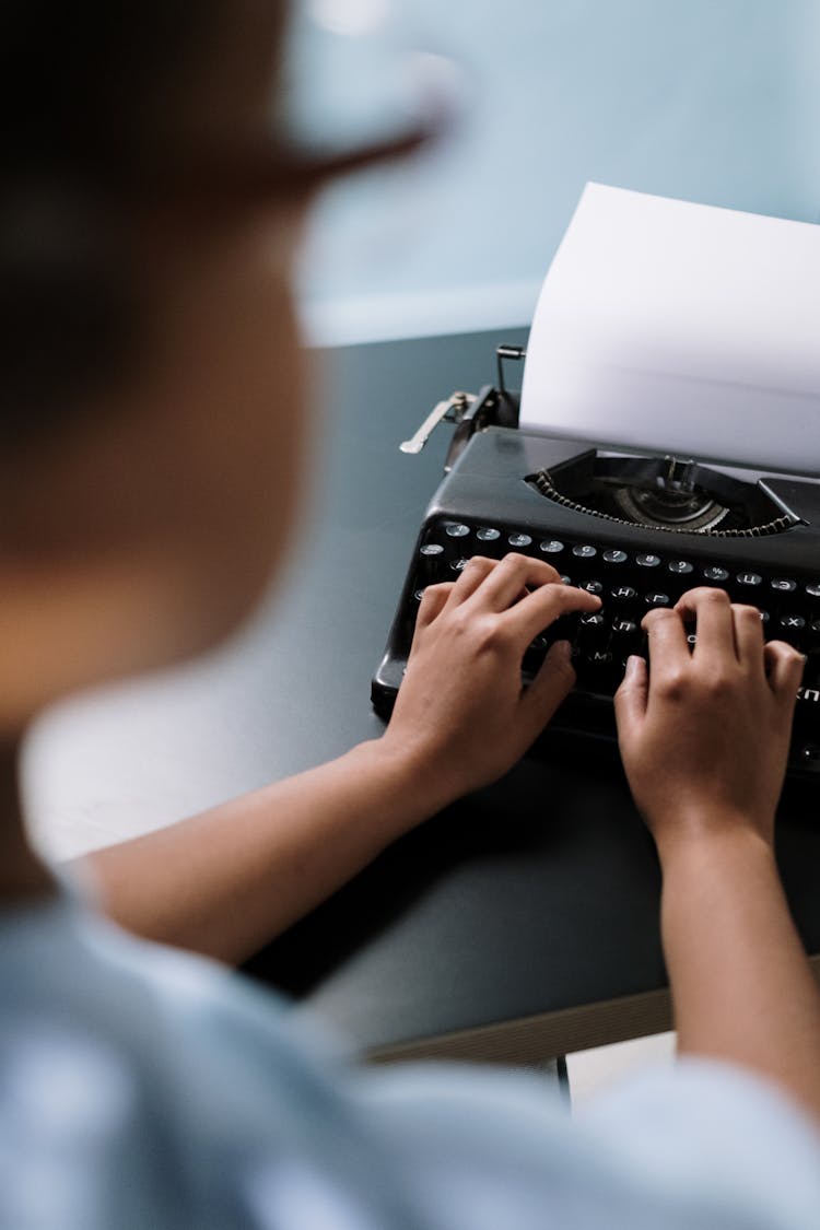 Man Writing On An Old Type Machine 