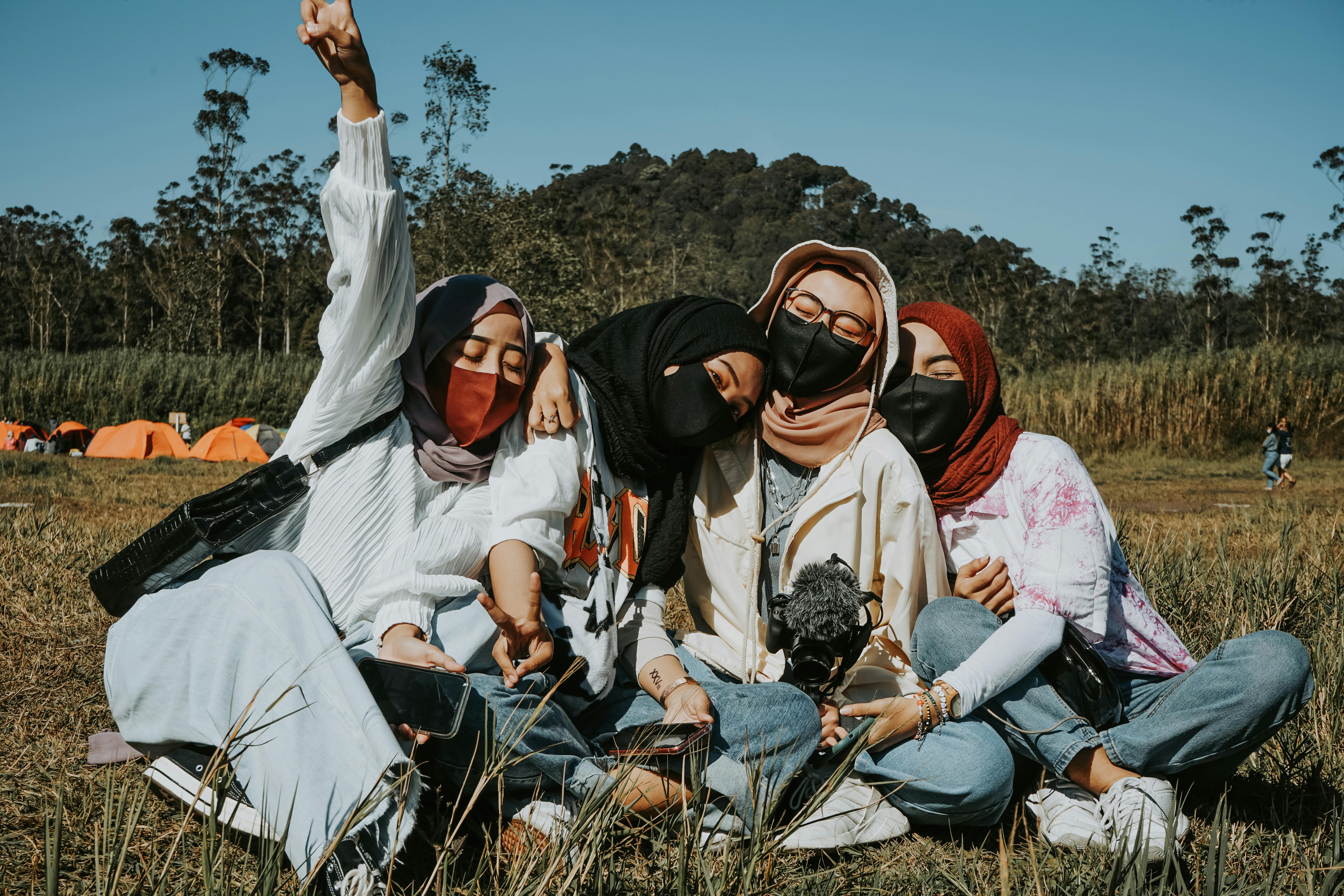 ethnic friends enjoying nature together in sunny day