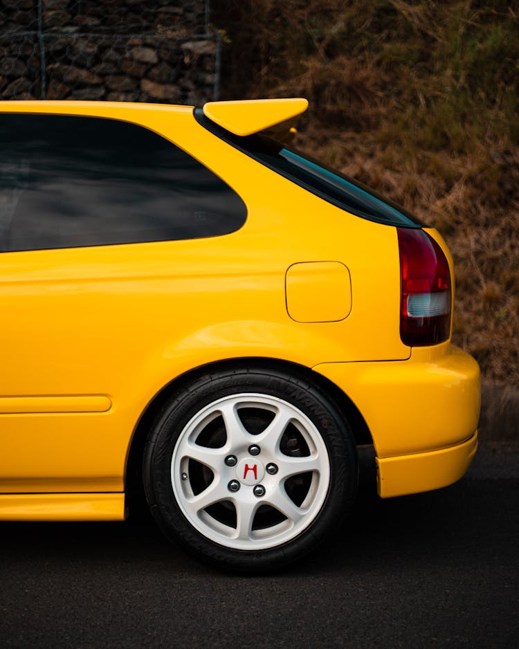 A Close-Up Shot Of A Yellow Honda Civic Hatchback