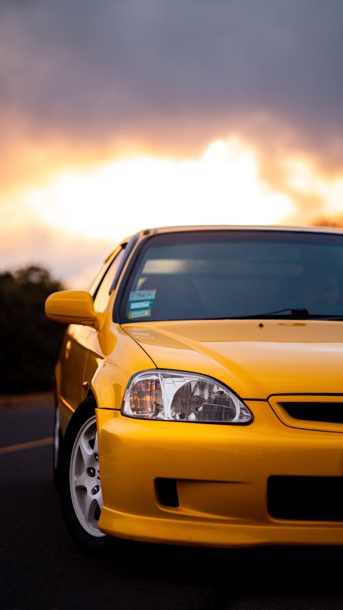 Yellow Car on Road During Sunset