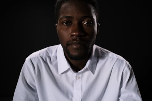 A Close-Up Shot of a Man Wearing a White Shirt