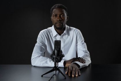 Host at a table with a studio microphone — cottonbro studio on Pexels