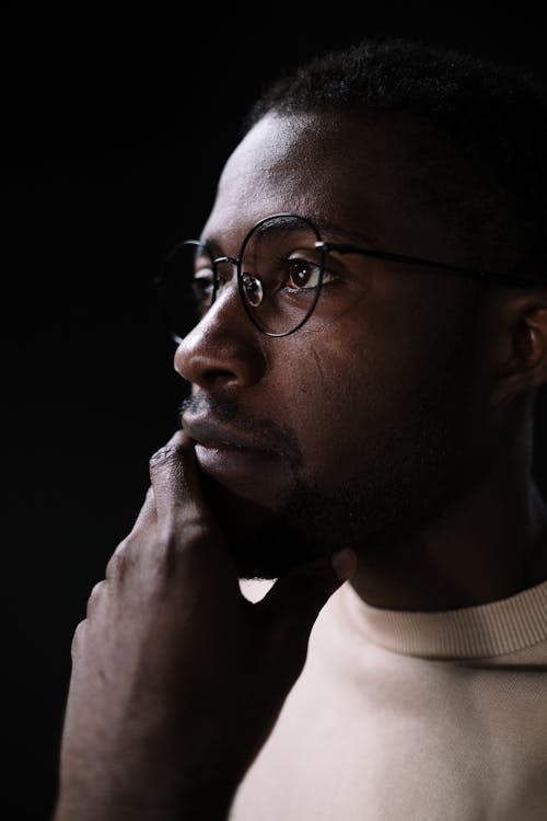 Close-Up Shot of a Man with Eyeglasses Thinking