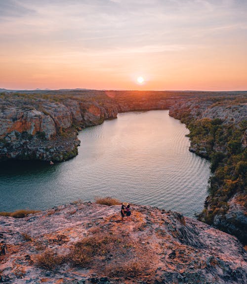 A Person on the Rocky Landscape Near the River