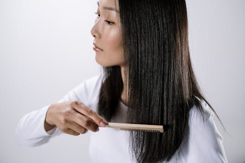 Woman Combing Her Black Hair