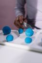 Person Holding Blue Round Ornament