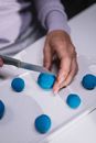 Person Holding Blue Egg on White Ceramic Plate