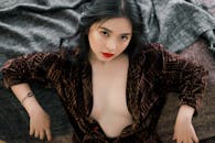 A High Angle Shot of a Woman in Brown Long Sleeves Looking with a Serious Face