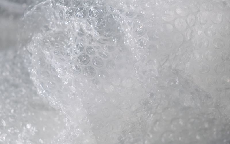 White EPE foam and bubble wrap packaging sheets in rolls