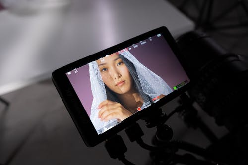 A Woman with Bubble Wrap Showing in the Monitor