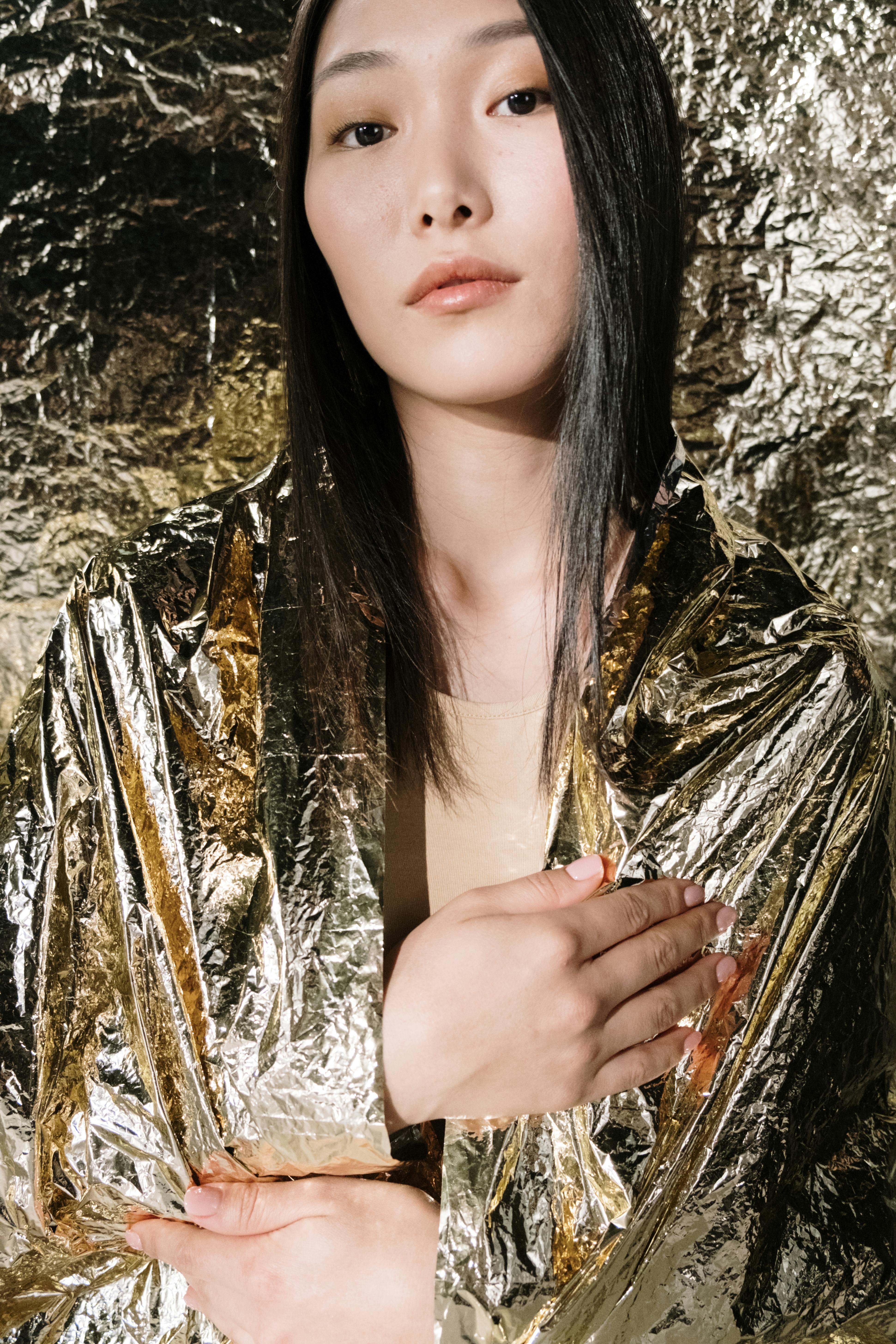 a woman wrapped in gold plastic