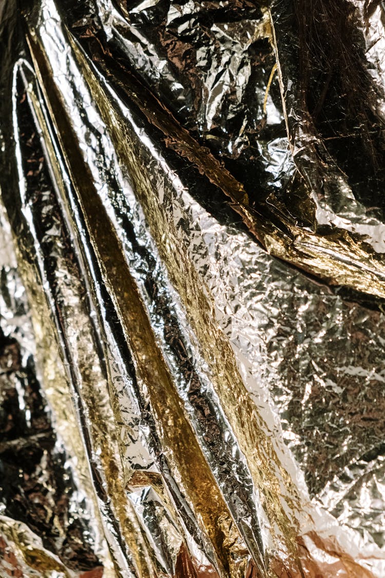 Close-Up Shot Of Crumpled Golden Plastic Wrapper