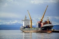 Cargo Ship on Sea Under White Clouds