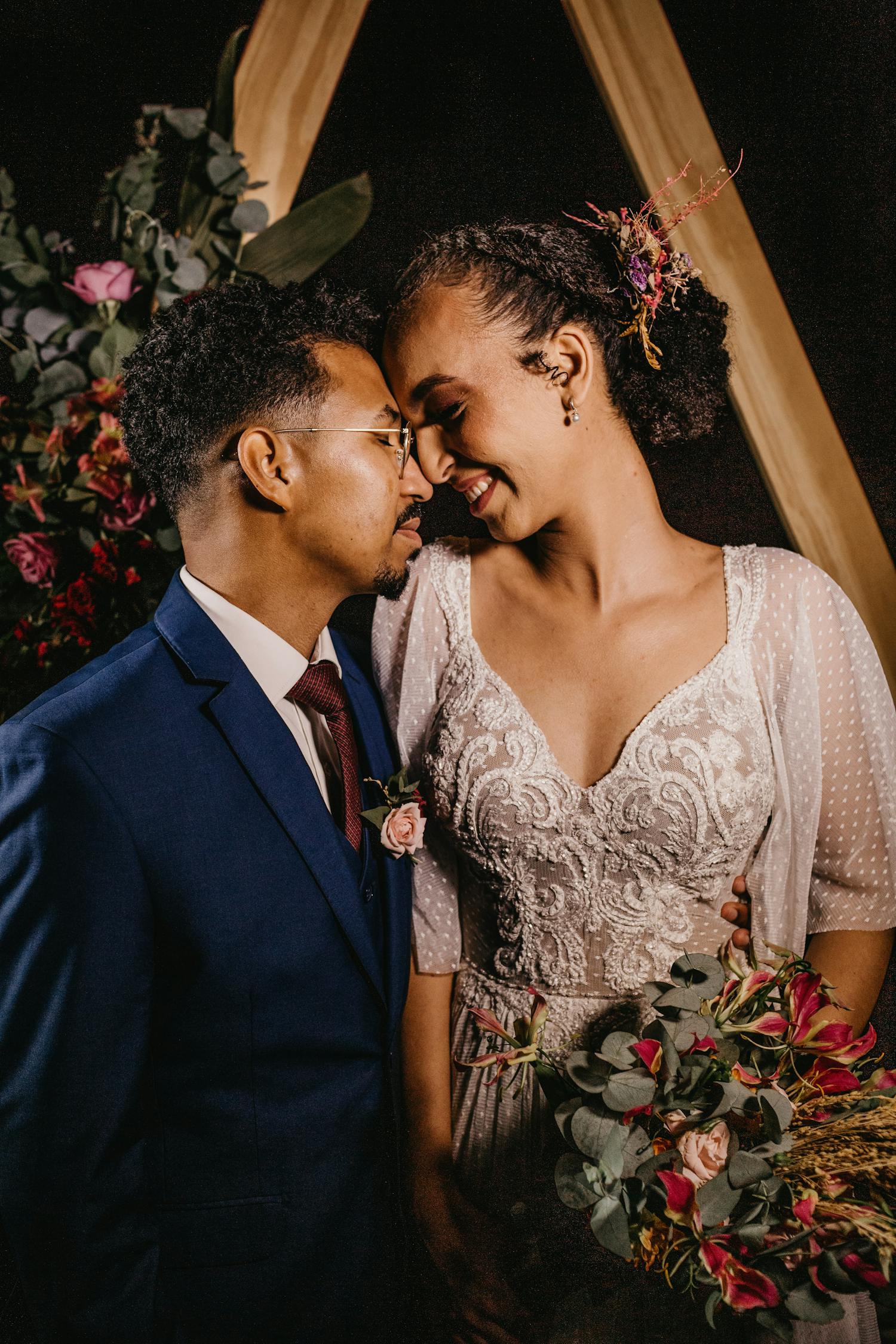 Smiling diverse couple with flower bouquet after getting married · Free