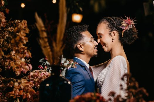 Glad bride with groom embracing during festive occasion