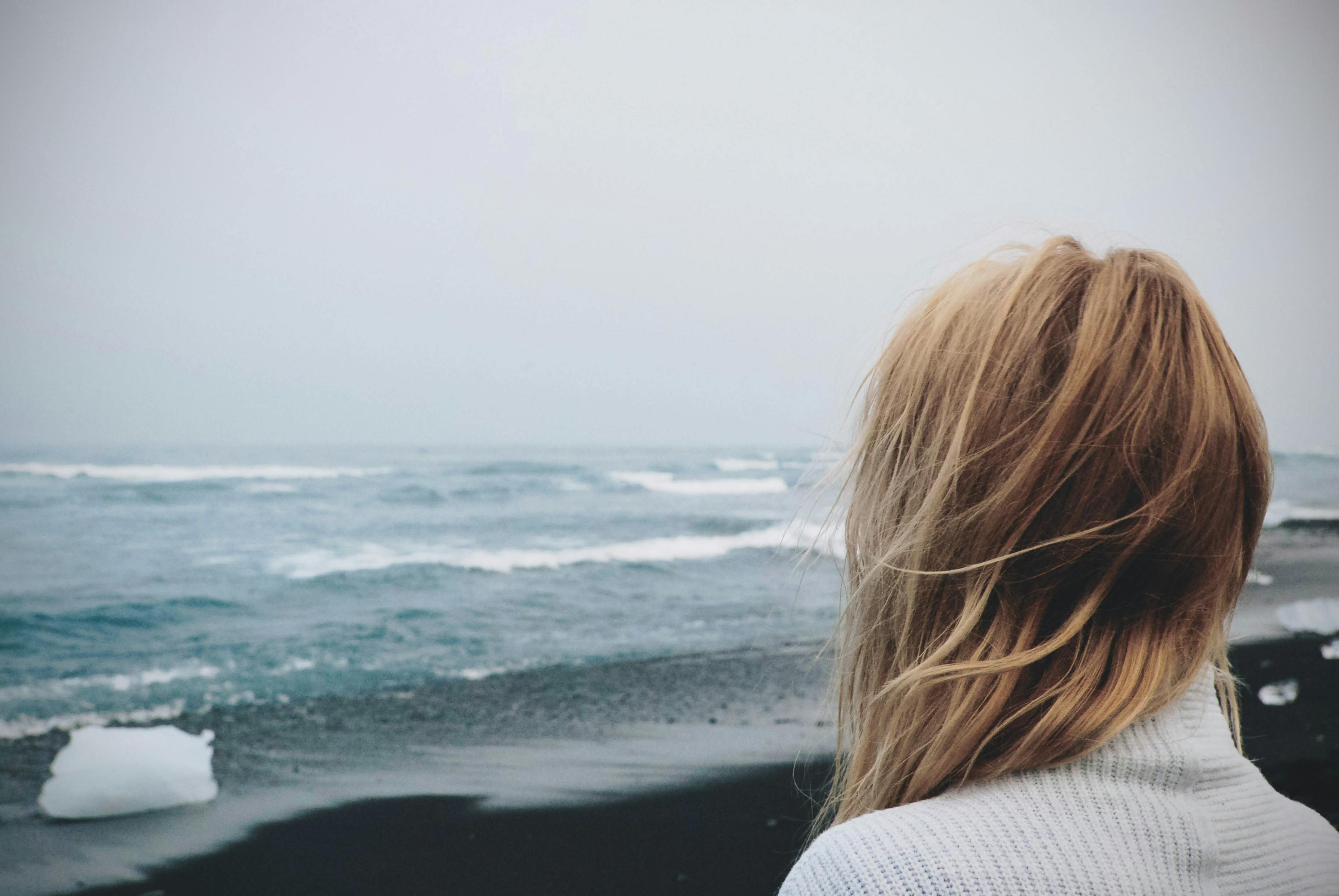 woman standing on shoreline