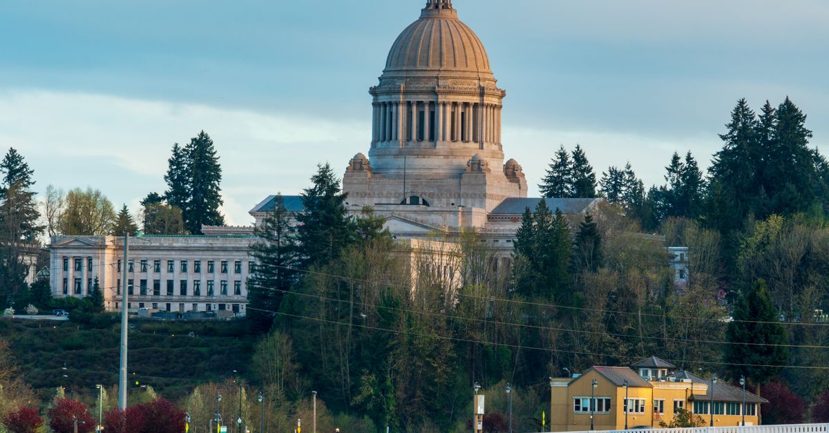 Scenic view of the Washington State Capitol building in Olympia surrounded by lush greenery.