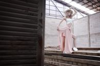 Woman in Pink Dress Standing on Brown Wooden Stairs