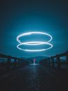 Person Walking on Pathway With Lights on the Side