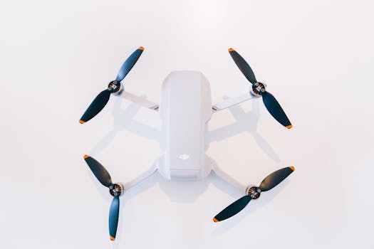 A high-tech drone with visible propellers against a clean white background, showcasing modern technology.