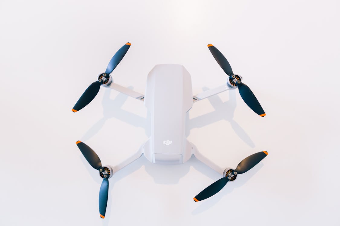 A White Drone with Black Propellers