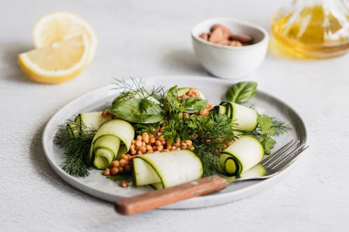 Free Sliced Lemon near White Ceramic Plate with Salad Stock Photo