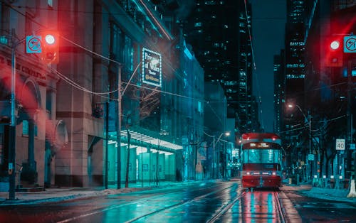 Red Bus on Road during Night Time