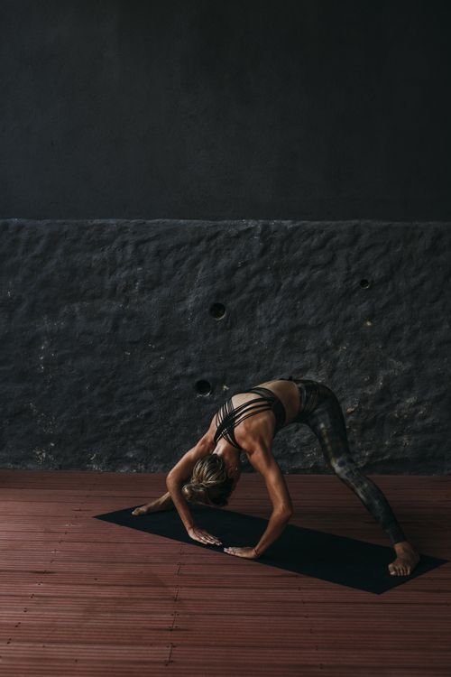 A Woman Stretching on a Yoga Mat · Free Stock Photo