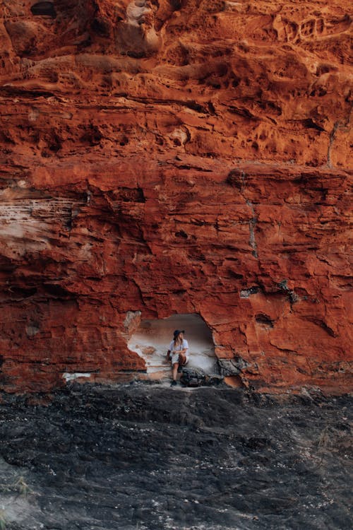 A Woman Sitting in a Cave