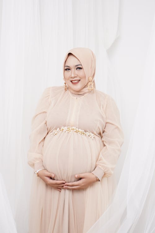 Pregnant Muslim Woman Holding Her Belly 