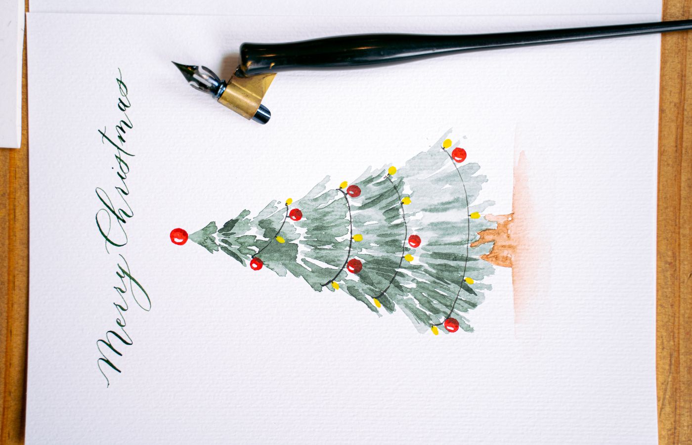 Elegant Christmas card featuring watercolor art and calligraphy. Perfect for the festive season.