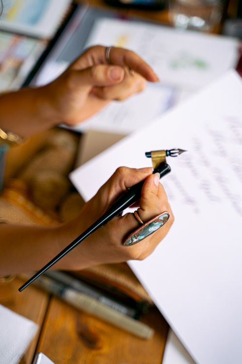Person Holding Black Pen · Free Stock Photo