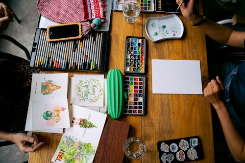 Paints and Markers on a Desk 