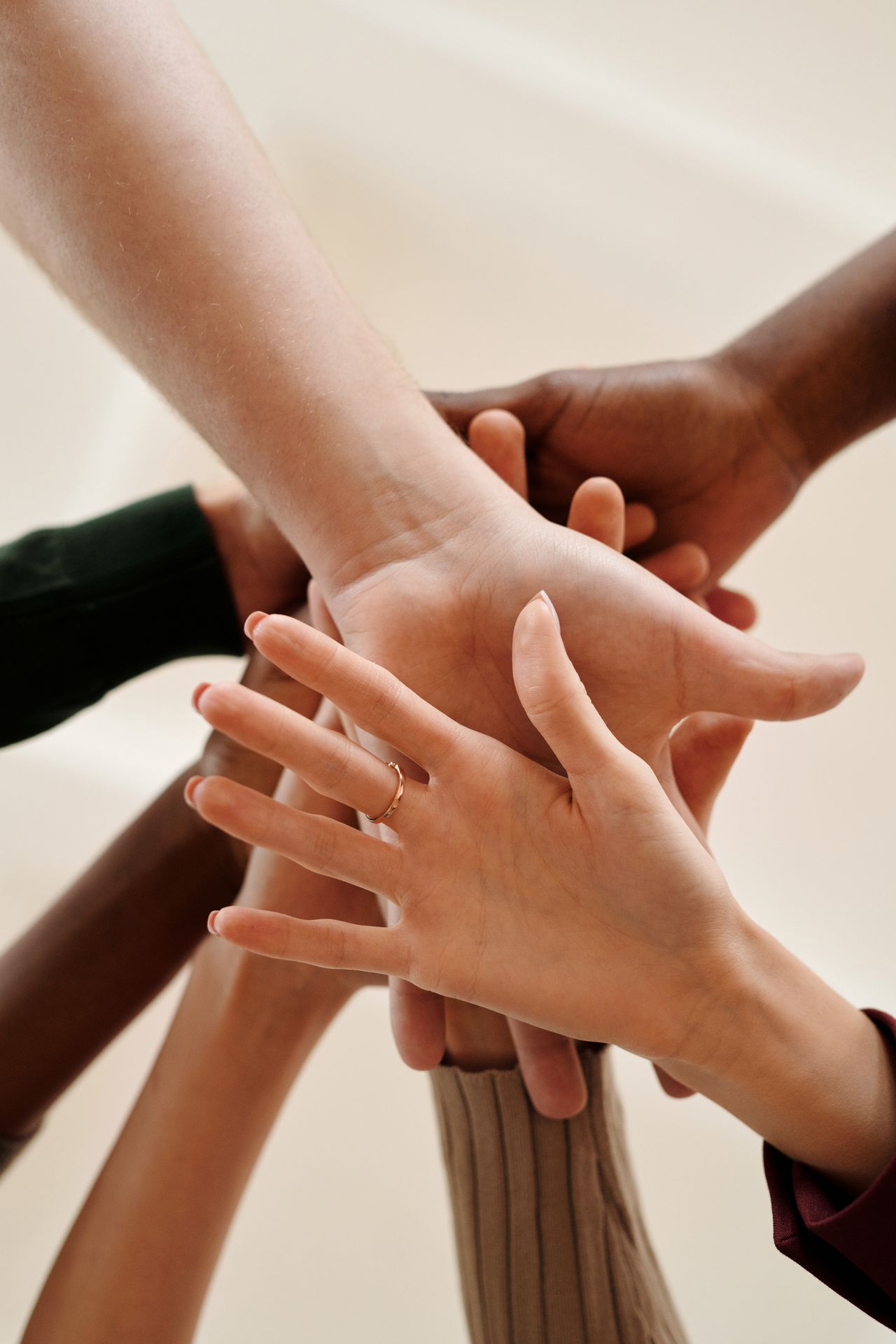 A close-up of diverse hands joined together symbolizing teamwork, cooperation, and unity