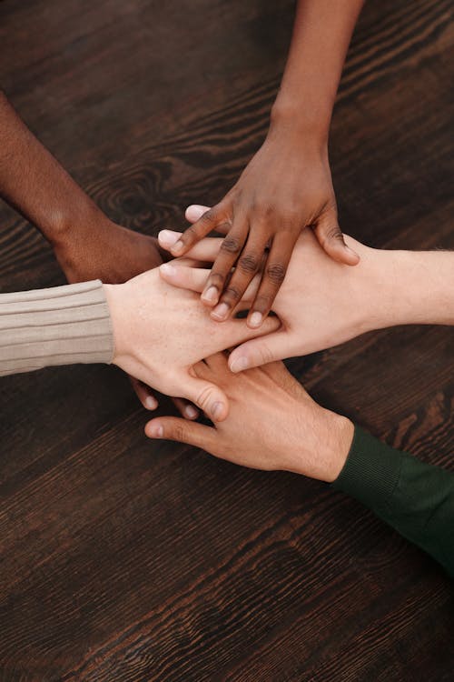 Hands on a Wooden Surface