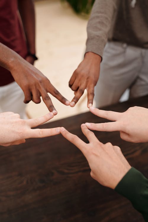 A Group People Touching Fingers