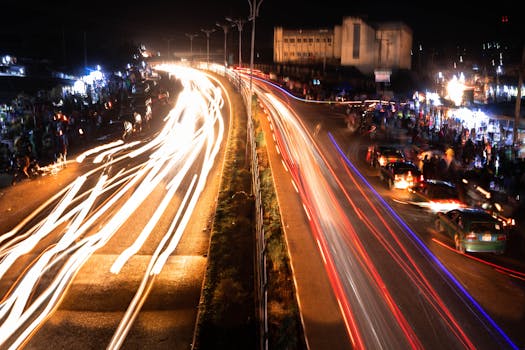 Dynamic nighttime street scene with light streaks in Abeokuta, Nigeria.