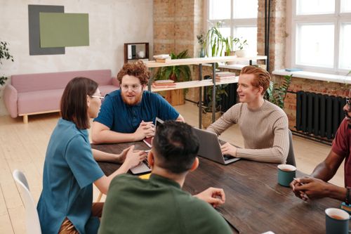 Free Professional team engaged in a collaborative work meeting in a modern office setting. Stock Photo