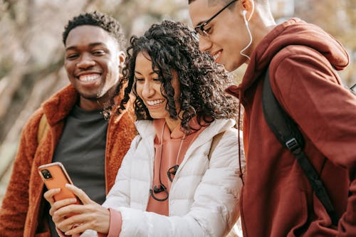 Free Cheerful multiethnic friends taking selfie together Stock Photo