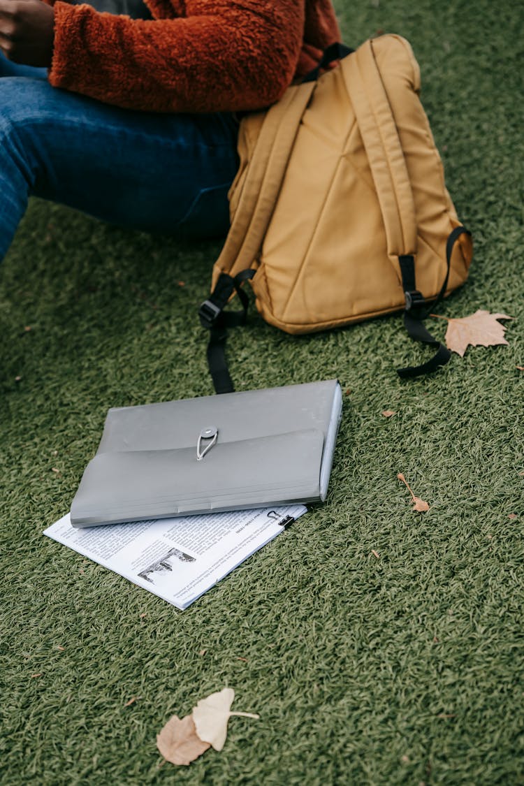 Crop Ethnic Student With Backpack And Newspaper