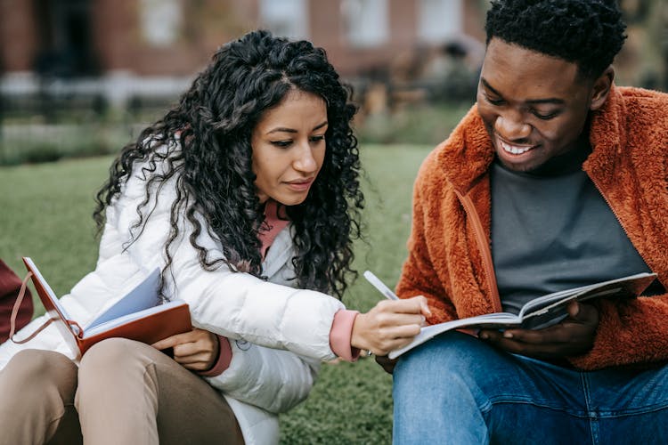 Cheerful Multiethnic Students Studying Together In Campus Park