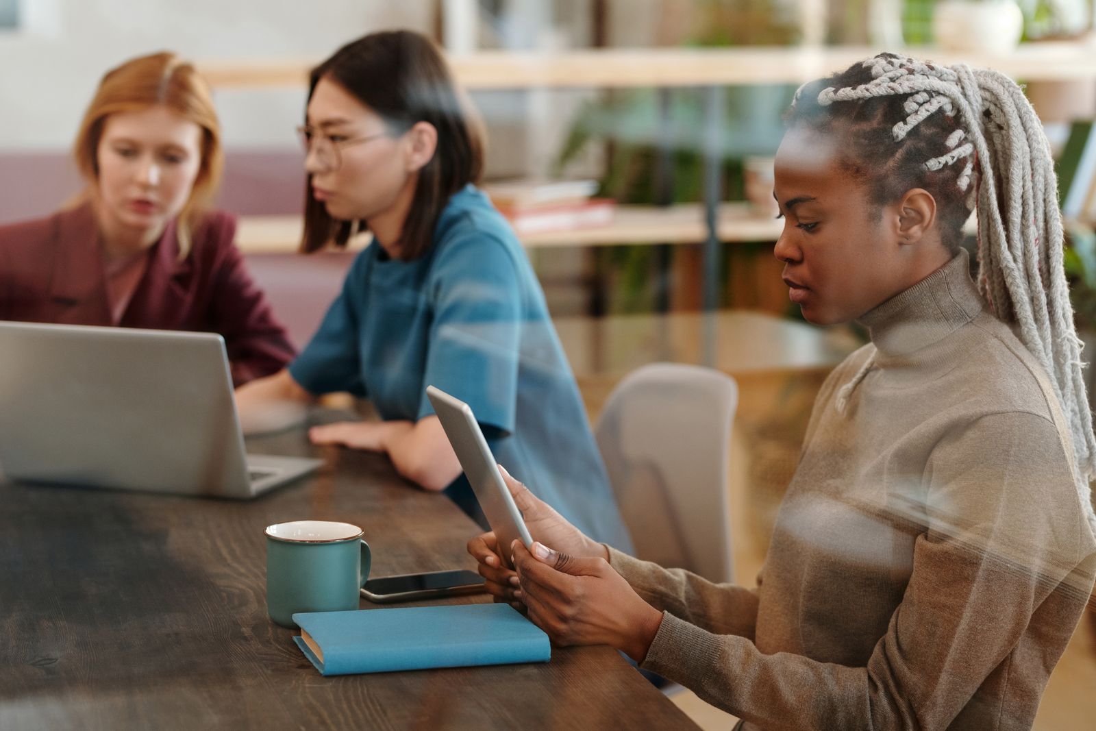 Women working together with technology in a modern office
