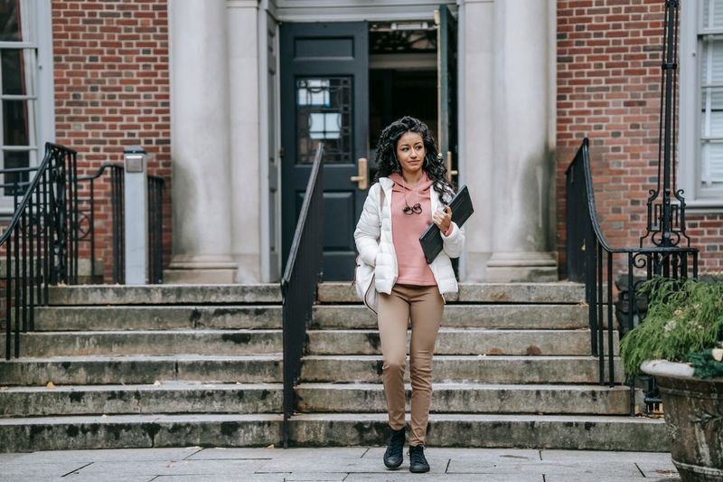 business casual outfit laid on a bed with shoes below