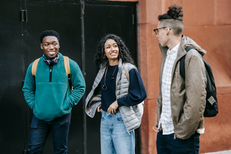 Group Of Joyful Young Multiethnic Friends Talking On Street After University Classes