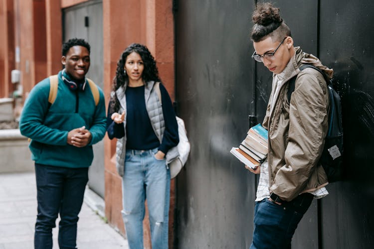 Multiethnic Friends Annoying Classmate In Yard