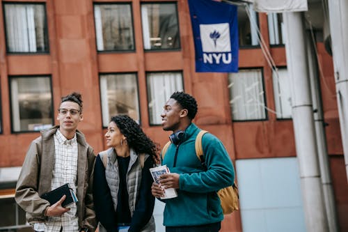 Group of multiethnic students standing near university