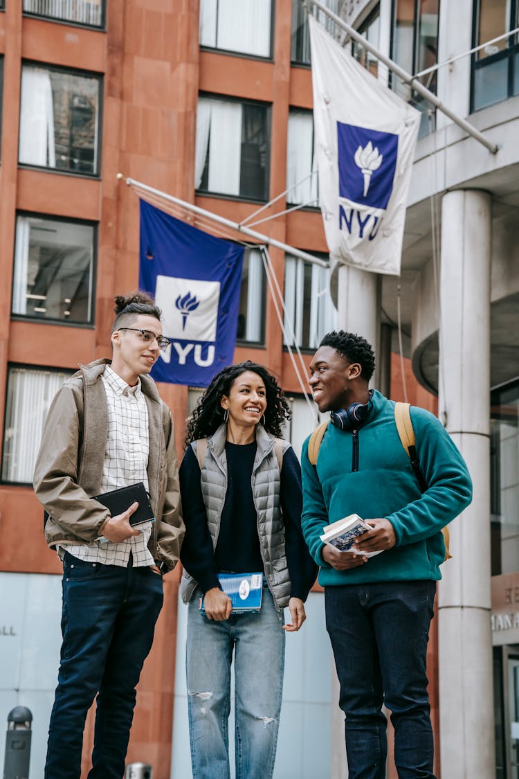 Group Of Diverse Students Near Building With Flags