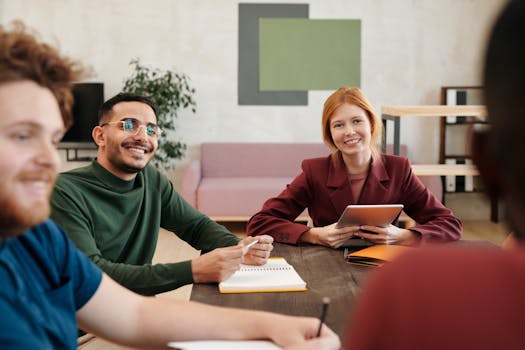 Group of diverse coworkers engaging in a productive team meeting in a modern workspace.