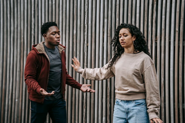 Expressive Multiethnic Couple Having Conflict On Street